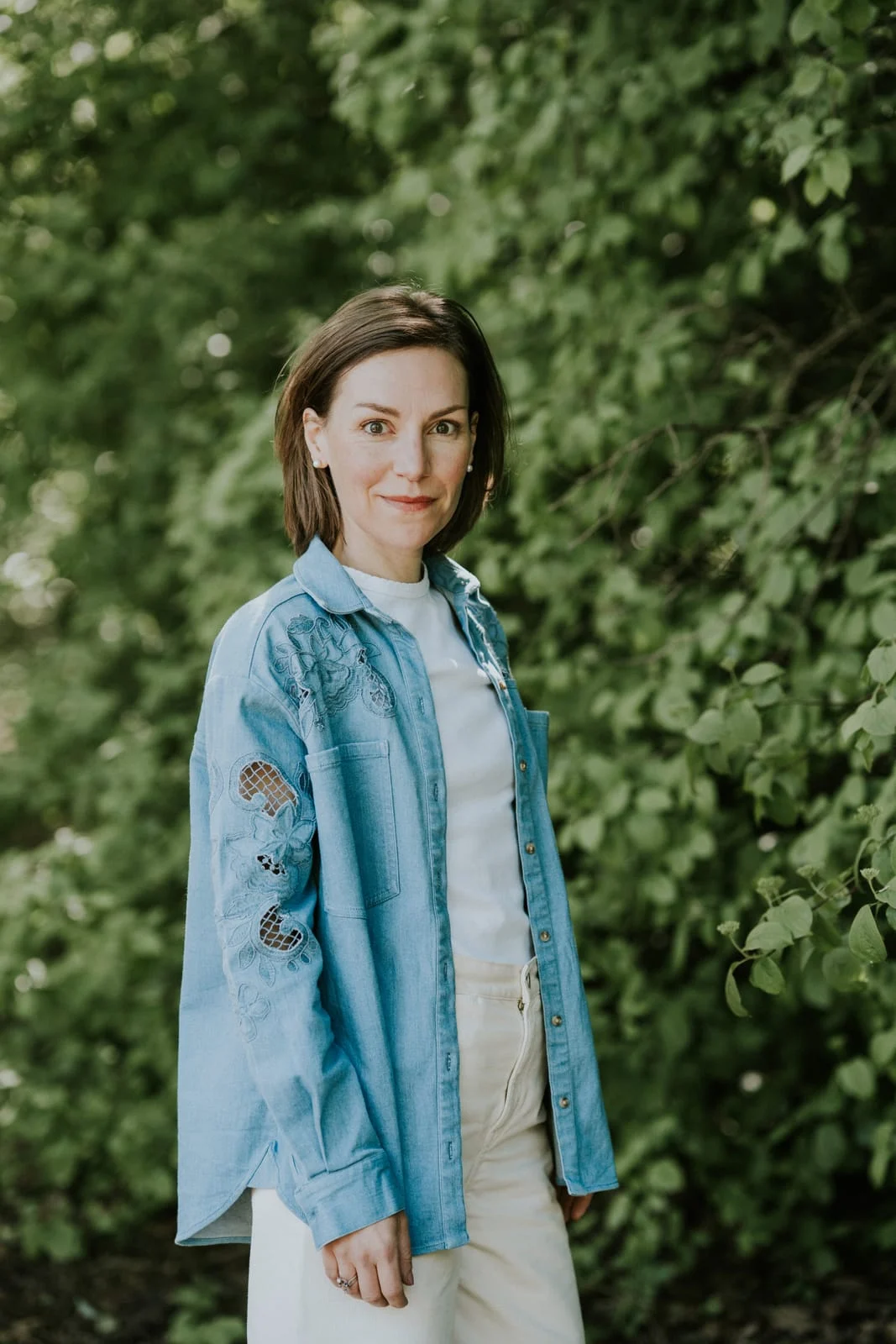 Aude en veste en jean devant la verdure
